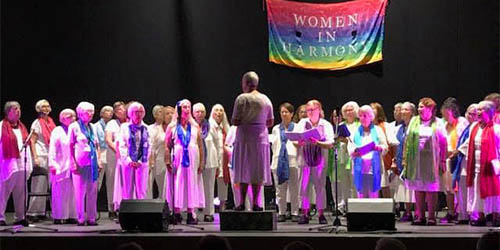 Women in harmony performing on stage